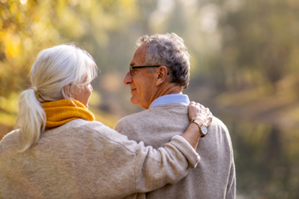 Photo of an elderly couple walking away